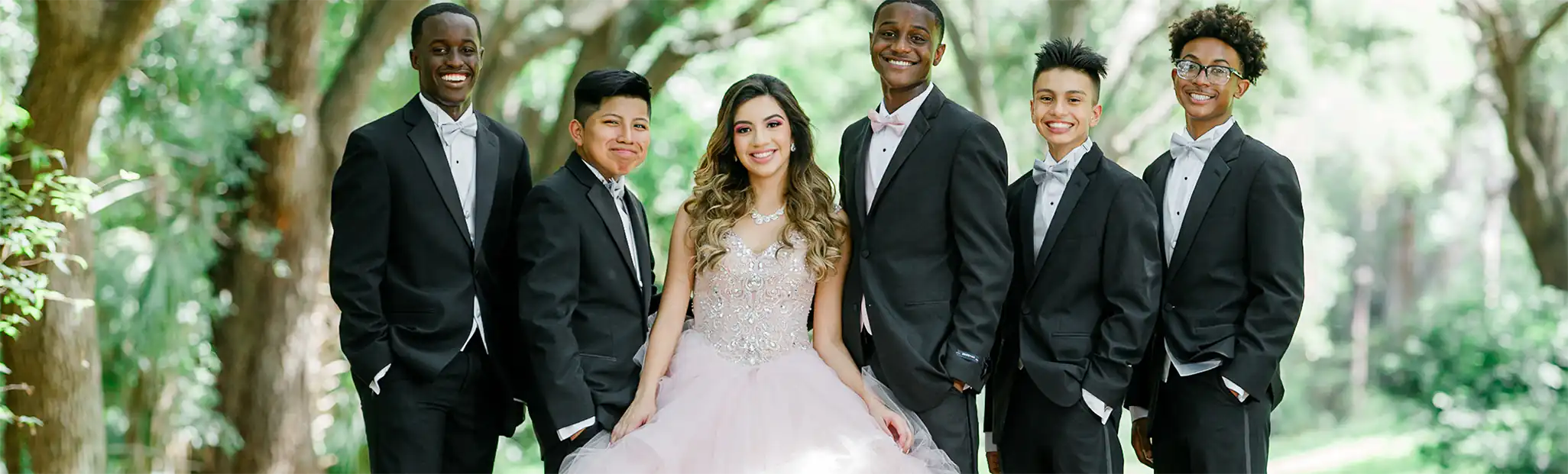 Quinceanera and young men in tuxedos